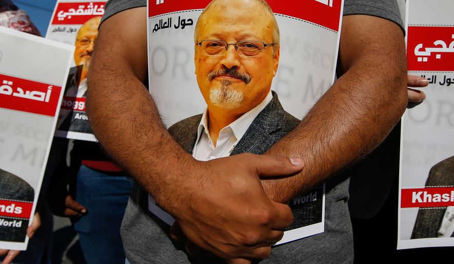 People hold posters of slain Saudi journalist Jamal Khashoggi, near the Saudi Arabia consulate in Istanbul, on Oct. 2, 2020. (AP Photo/Emrah Gurel, File)