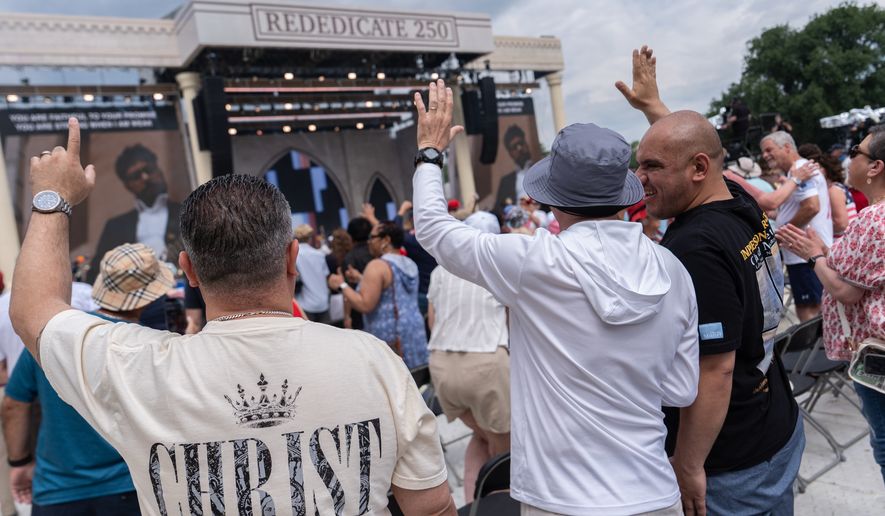 People worship to Christian music at Rededicate 250, a mostly conservative Christian prayer gathering in honor of the United States' 250th anniversary, on the National Mall, Sunday, May 17, 2026, in Washington. (AP Photo/Julia Demaree Nikhinson)