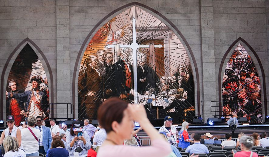 A person prays during Rededicate 250, a mostly conservative Christian prayer gathering in honor of the United States' 250th anniversary, on the National Mall, Sunday, May 17, 2026, in Washington. (AP Photo/Julia Demaree Nikhinson)