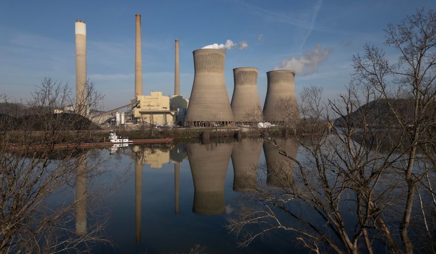 American Electric Power's John Amos coal-fired power plant in Winfield, W.Va., is seen across the Kanawha River from Poca, W.Va., March 22, 2026. (AP Photo/Carolyn Kaster, File)