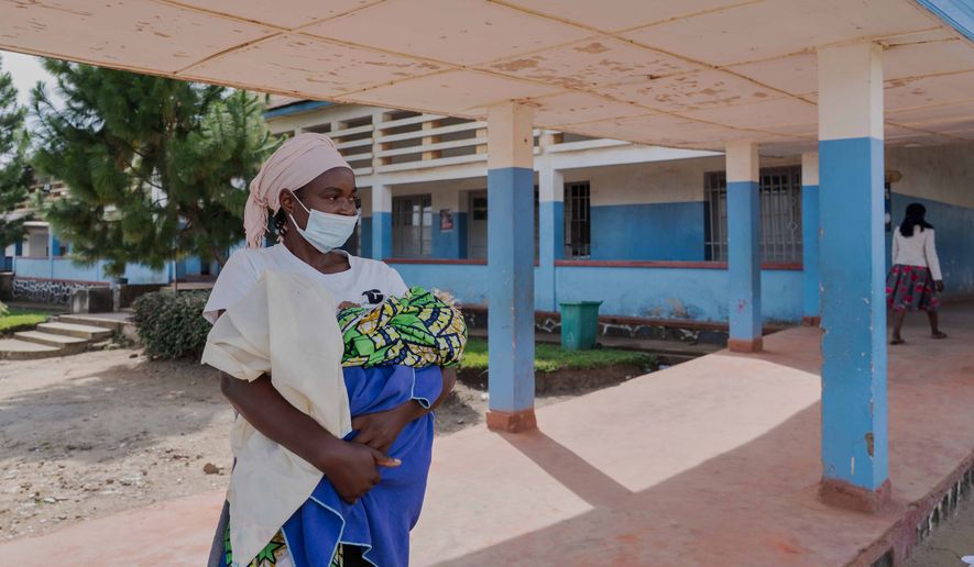 A woman wearing a protective mask stands in the corridor of a hospital in Bunia, Congo, Sunday, May 17, 2026. (AP Photo/ Dirole Lotsima Dieudonne)