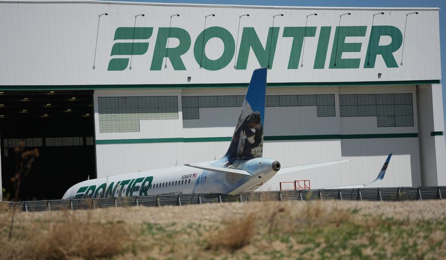 A Frontier Airlines jetliner sits outside a repair hangar at Denver International Airport, Monday, May 11, 2026. (AP Photo/David Zalubowski)