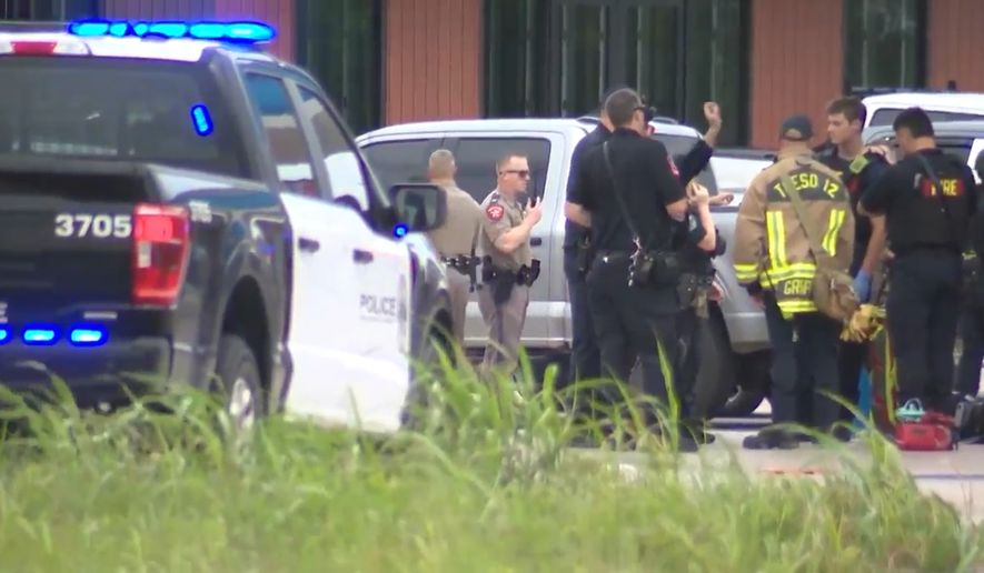 In this image taken from video provided by KVUE, emergency cervices work on a site of a shooting in Austin, Texas, Sunday, May 17, 2026. (KVUE via AP)