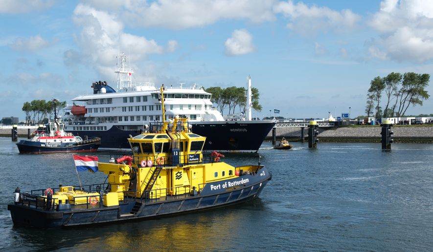 The MV Hondius cruise ship, center, arrives at the Port of Rotterdam, Netherlands, Monday, May 18, 2026. (AP Photo/Patrick Post)