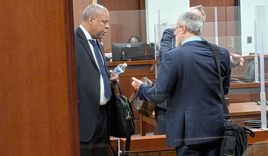 Attorney Calvin Osborne (left) talks with property managing firm Quasar's Kenneth Brown after a Maryland circuit court judge denied a request from Marylander Condominiums residents seeking to remove the property management company on Monday, May 18, 2026, at the Prince George's County Court House in Upper Marlboro. The Adelphi condos, adjoining a homeless encampment, have been without heat since November 2025. (Sean Salai/The Washington Times)