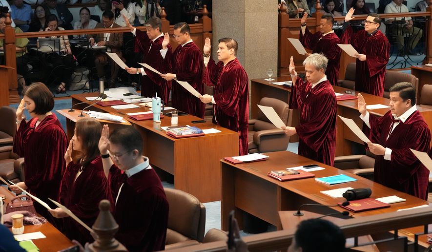 Philippine senators take oath as they convene as an impeachment court for the trial of Vice President Sara Duterte at the Philippine senate, Monday, May 18, 2026, in Pasay, Philippines. (AP Photo/Aaron Favila)