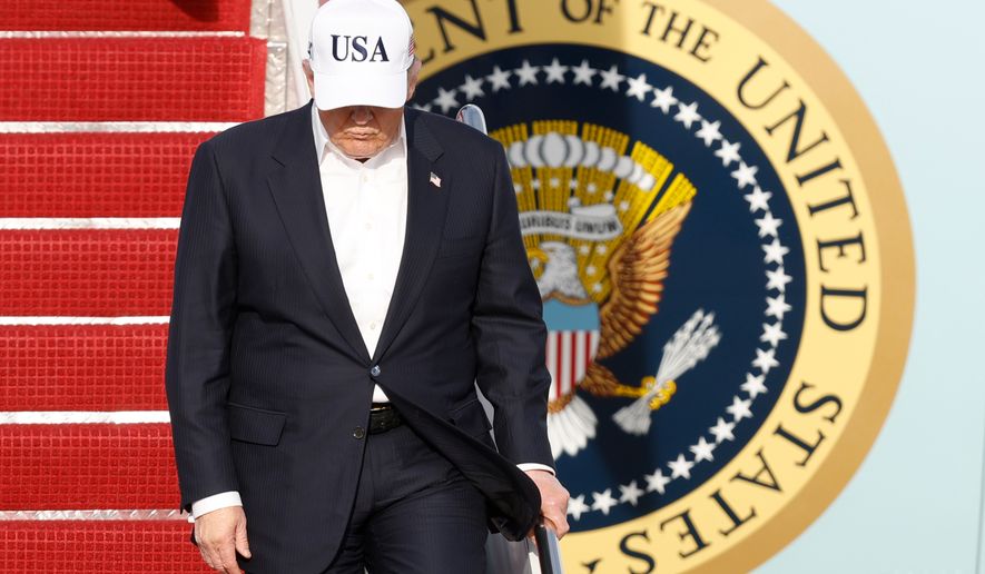 President Donald Trump walks down the stairs of Air Force One upon his arrival at Joint Base Andrews, Md., Friday, May 15, 2026. (AP Photo/Luis M. Alvarez)
