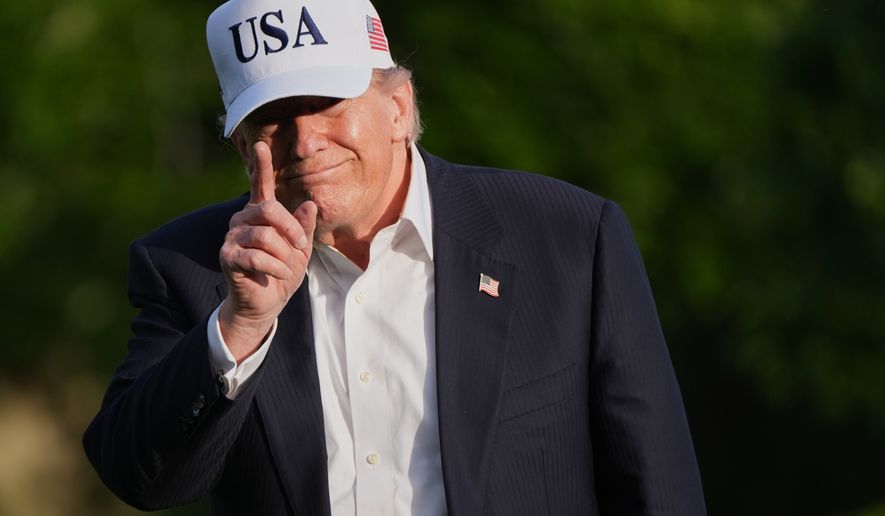 President Donald Trump gestures to reporters as he walks across the South Lawn of the White House, Friday, May 15, 2026, in Washington, on return from Beijing where he met with China's President Xi Jinping. (AP Photo/Jacquelyn Martin)