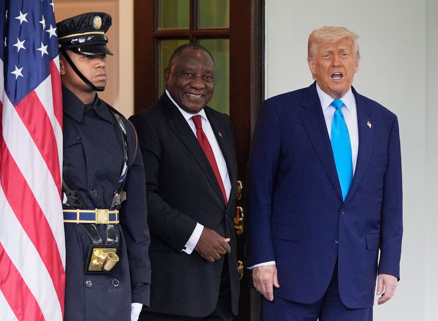 President Donald Trump greets South African President Cyril Ramaphosa, center, at the White House, May 21, 2025, in Washington. (AP Photo/Julia Demaree Nikhinson, File)