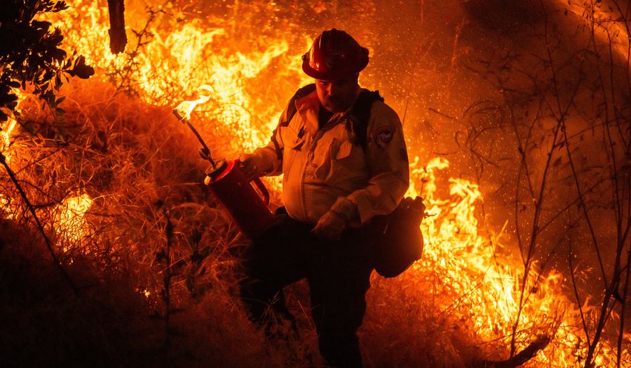 Fire crews conduct a firing operation to control the Sandy Fire Monday, May 18, 2026, in Simi Valley, Calif. (AP Photo/Ethan Swope)