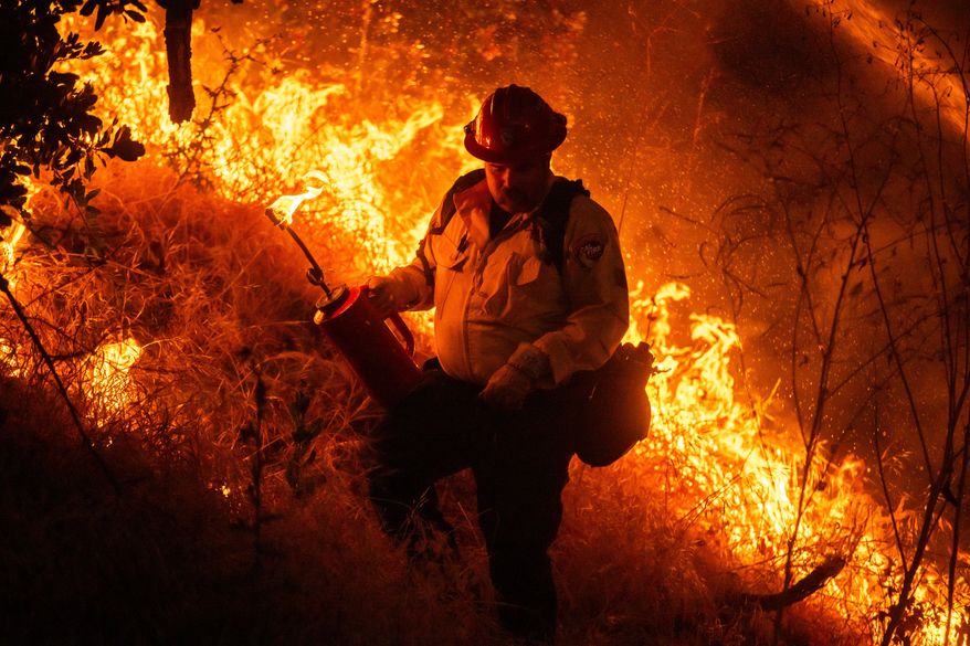 Fire crews conduct a firing operation to control the Sandy Fire Monday, May 18, 2026, in Simi Valley, Calif. (AP Photo/Ethan Swope)