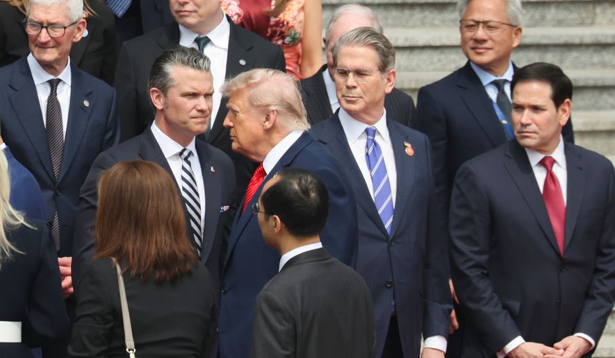 U.S. President Donald Trump looks on next to, from bottom right, U.S. Secretary of State Marco Rubio, U.S. Treasury Secretary Scott Bessent, U.S. Defense Secretary Pete Hegseth, Nvidia CEO Jensen Huang, top right, Tesla CEO Elon Musk, Apple CEO Tim Cook, top left, and others during a welcome ceremony at the Great Hall of the People in Beijing, Thursday, May 14, 2026. (Maxim Shemetov/Pool Photo via AP)
