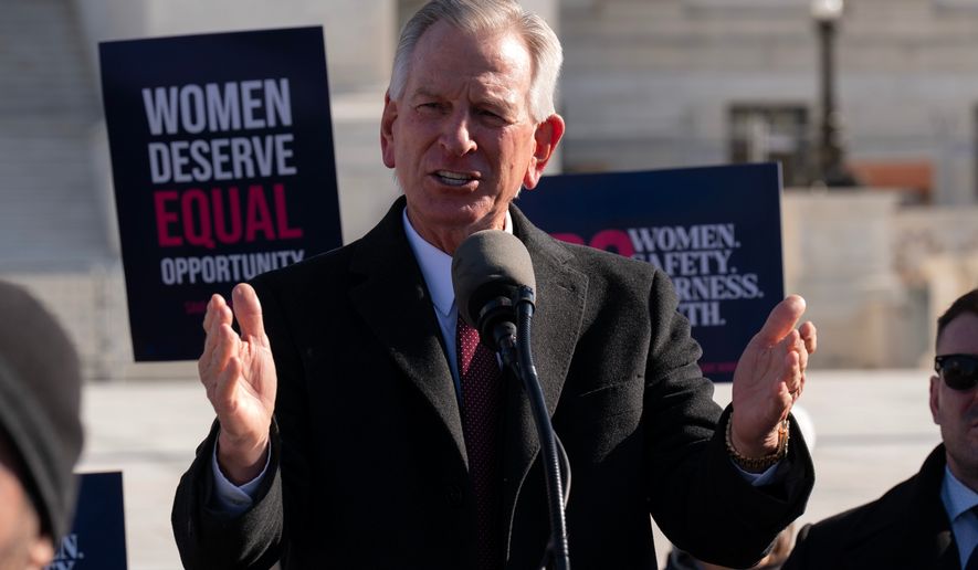 Sen. Tommy Tuberville, R-Ala., speaks to the crowd as protesters gather outside the Supreme Court as it hears arguments over state laws barring transgender girls and women from playing on school athletic teams, Jan. 13, 2026, in Washington. (AP Photo/Jose Luis Magana, File)