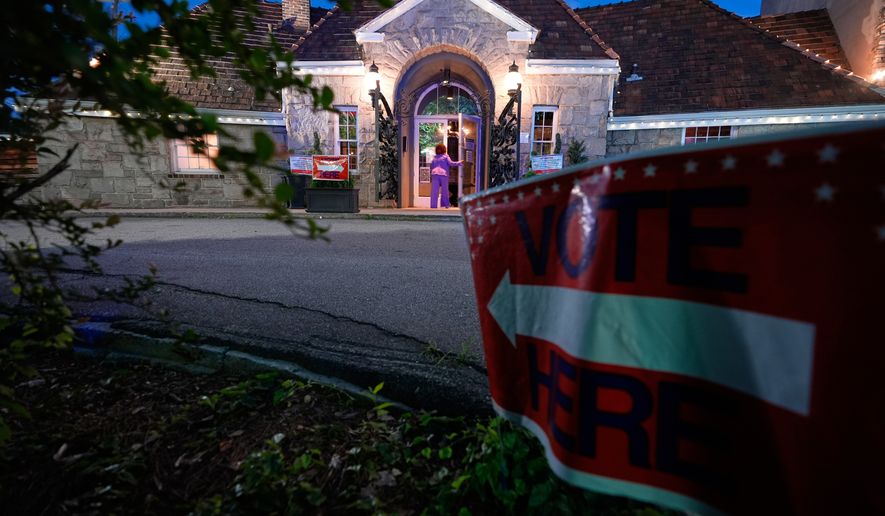 A sign directs voters arriving to vote in the Georgia primary elections on Tuesday, May 19, 2026, in Atlanta. (AP Photo/Brynn Anderson)