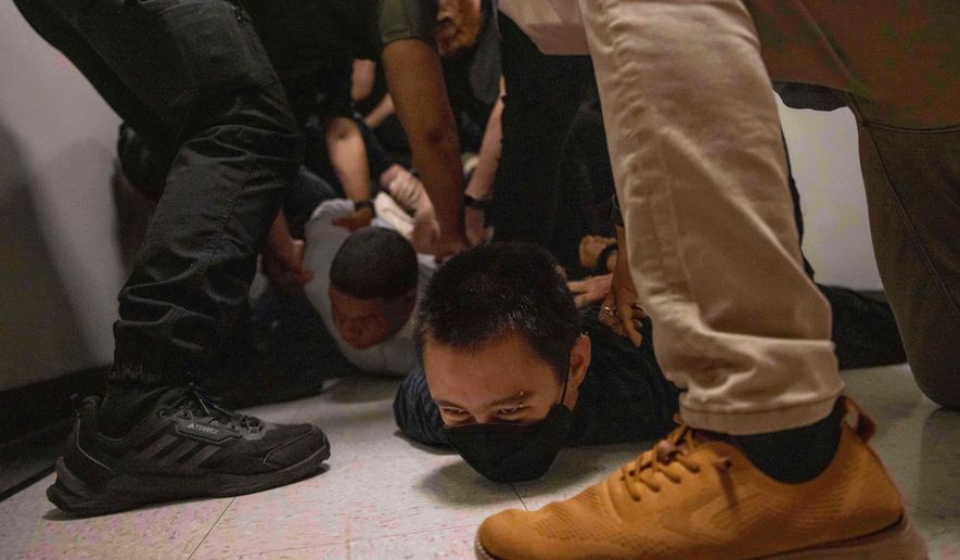 FILE - A Dominican man, left, and an activist, right, are detained by plainclothes officers with Immigration and Customs Enforcement after an immigration hearing at the immigration court inside the Jacob K. Javits Federal Building in New York, on June 6, 2025. (AP Photo/Yuki Iwamura, File)