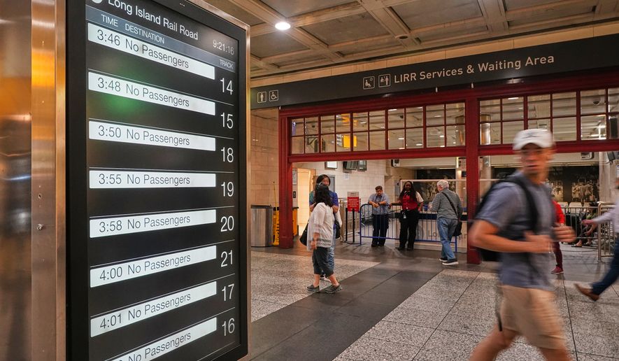 Rail passengers pass the Long Island Rail Road waiting room in Penn Station, in New York, Tuesday, May 19, 2026. (AP Photo/Richard Drew)