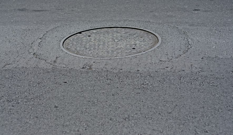 A 56-year-old woman died from her injuries after falling about 10 feet into an open manhole in Manhattan late Monday night. (File Photo credit: Pheobus via Shutterstock)