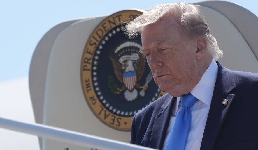 President Donald Trump walks off Air Force One, Wednesday, May 20, 2026, on arrival to Groton-New London Airport, in Groton, Conn., en route to speak at the U.S. Coast Guard Academy commencement. (AP Photo/Jacquelyn Martin)