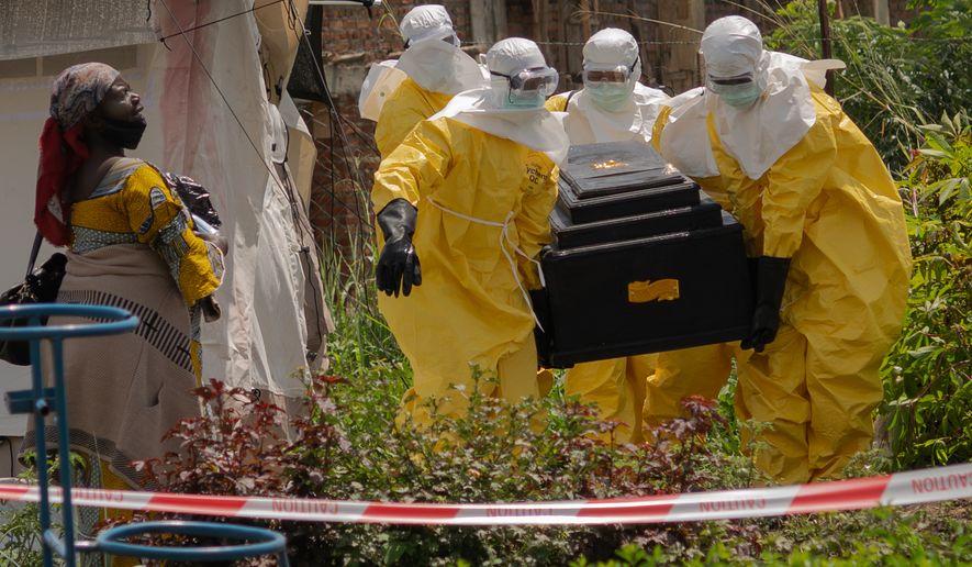 A woman cries as Red Cross workers carry the coffin of a person who died of Ebola from a health center in Rwampara, Congo, Wednesday, May 20, 2026. (AP Photo/Moses Sawasawa)