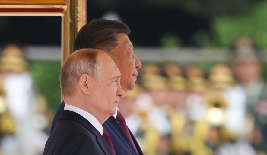 Russian President Vladimir Putin, foreground and Chinese President Xi Jinping attend a welcoming ceremony at the Great Hall of the People in Beijing Wednesday, May 20, 2026. (Maxim Shemetov/Pool Photo via AP)