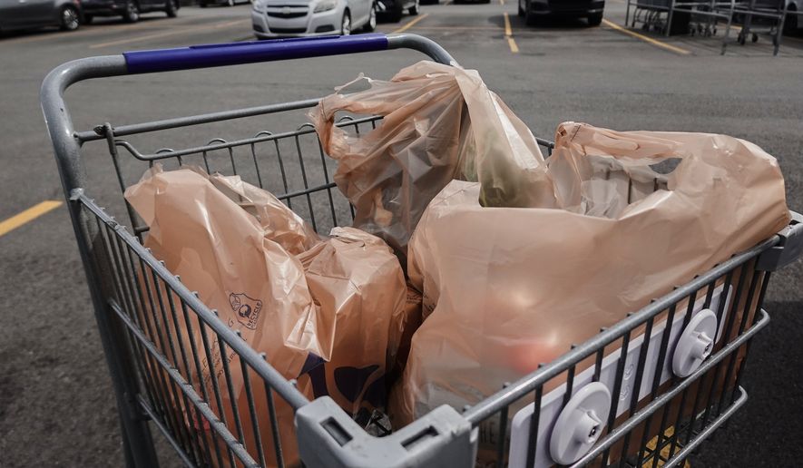 Plastic bags with groceries sit in a cart Monday, May 18, 2026, in Cincinnati. (AP Photo/Joshua A. Bickel)