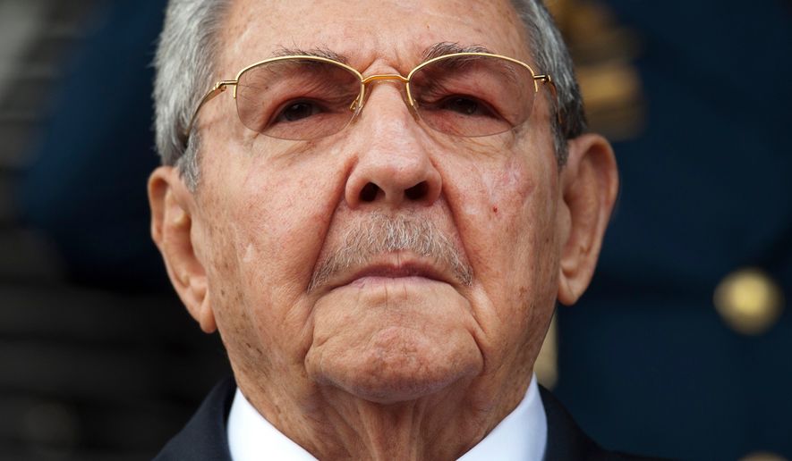 FILE - Cuba's President Raul Castro listens to the Cuban and Venezuelan national anthems during his welcome ceremony at the Miraflores presidential palace in Caracas, Venezuela, March 17, 2015. (AP Photo/Ariana Cubillos, File)