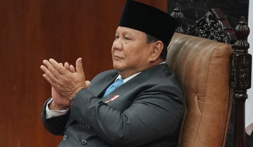 Indonesia's President Prabowo Subianto applauds as he attends a House of Representatives plenary session in Jakarta, Indonesia, Wednesday, May 20, 2026. (AP Photo/Achmad Ibrahim)