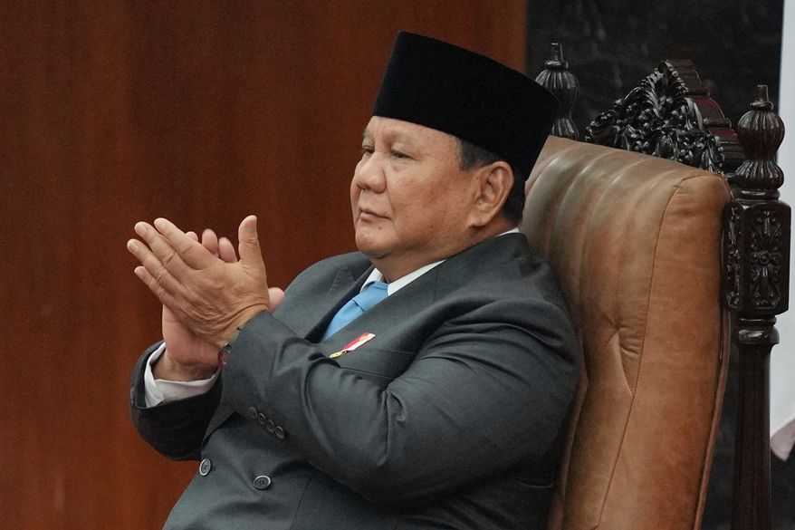 Indonesia's President Prabowo Subianto applauds as he attends a House of Representatives plenary session in Jakarta, Indonesia, Wednesday, May 20, 2026. (AP Photo/Achmad Ibrahim)
