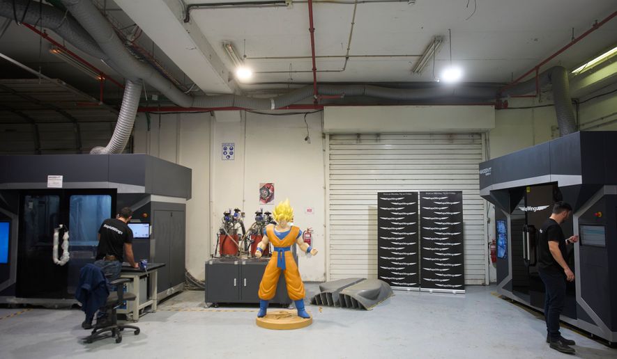 Workers operate a 3D printer that makes drone parts at the headquarters of Masssivit in Lod, Israel, March 30, 2026. (AP Photo/Ohad Zwigenberg)