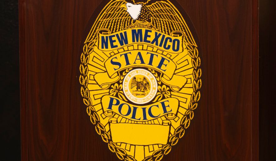 A New Mexico State Police emblem is displayed on podium during a news conference, March 16, 2024, in Albuquerque, N.M. (Jon Austria/The Albuquerque Journal via AP, File)