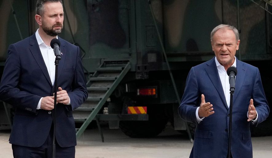 FILE - Poland's Prime Minister Donald Tusk, right, and Defense Minister Wladyslaw Kosiniak-Kamysz, visit troops who patrol Poland's border with Belarus, in Dubicze Cerkiewna, eastern Poland on May 29, 2024. (AP Photo/Czarek Sokolowski, File)