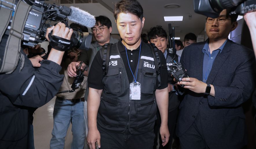 Choi Seung-ho, a leader of the Samsung Electronics labor union, leaves after attending the government-led mediation talks with management at the National Labor Relations Commission office in Sejong, South Korea, Wednesday, May 20, 2026 (Yonhap via AP)