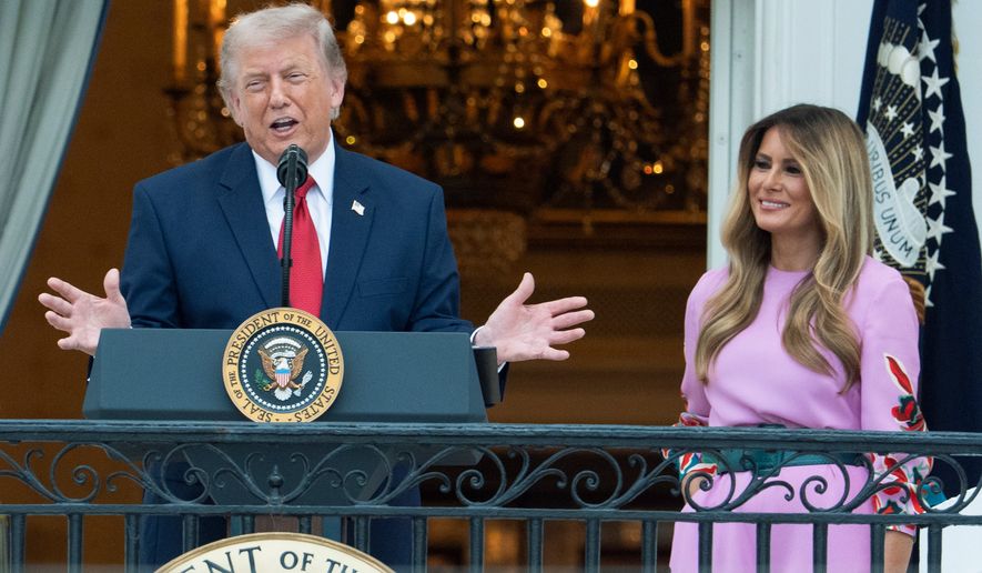 President Donald Trump with first lady Melania Trump addresses the attendees from the Blue Room Balcony of the White House during the annual Congressional Picnic on the South Lawn, Tuesday, May 19, 2026, in Washington. (AP Photo/Manuel Balce Ceneta)