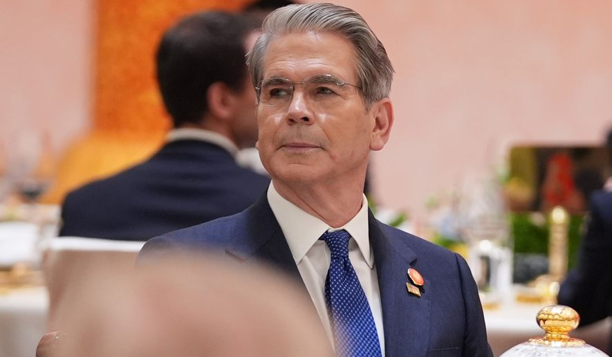 Treasury Secretary Scott Bessent listens during a state dinner with President Donald Trump and Chinese President Xi Jinping at the Great Hall of the People on Thursday May 14, 2026, in Beijing. (AP Photo/Mark Schiefelbein)