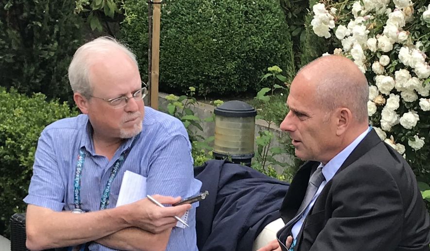 Howard Fendrich, left, Associated Press national sports writer, interviews former French tennis player Guy Forget at the 2019 French Open tennis tournament in Paris. (AP Photo/Andrew Dampf)