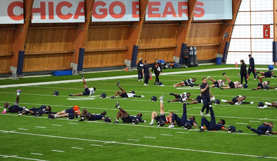 Chicago Bears players warm up during the NFL football team's rookie minicamp, Friday, May 8, 2026, in Lake Forest, Ill. (AP Photo/Nam Y. Huh)