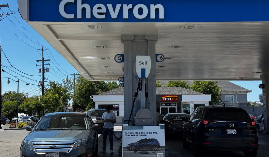 A sign blaming Sacramento policies for high gas prices is displayed at a Chevron gas station in Alameda, Calif., on Thursday, May 21, 2026. (AP Photo/Terry Chea)