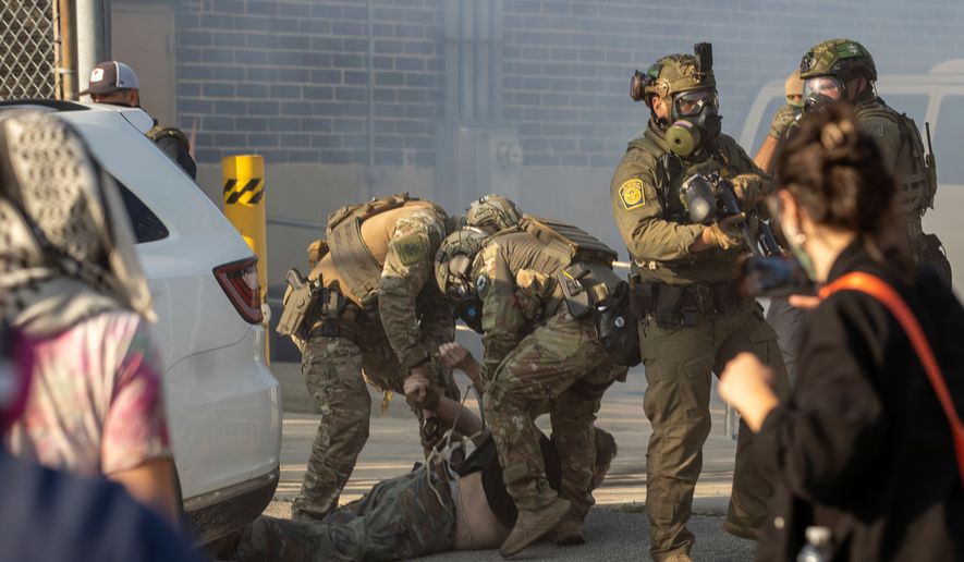 Immigration and Customs Enforcement officers arrest a protester at the ICE facility in Broadview, Ill., on Sept. 19, 2025. (Zubaer Khan /Chicago Sun-Times via AP) **FILE**