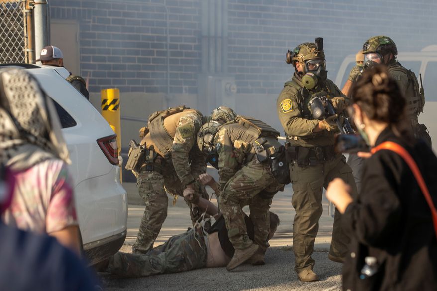 Immigration and Customs Enforcement officers arrest a protester at the ICE facility in Broadview, Ill., on Sept. 19, 2025. (Zubaer Khan /Chicago Sun-Times via AP) **FILE**