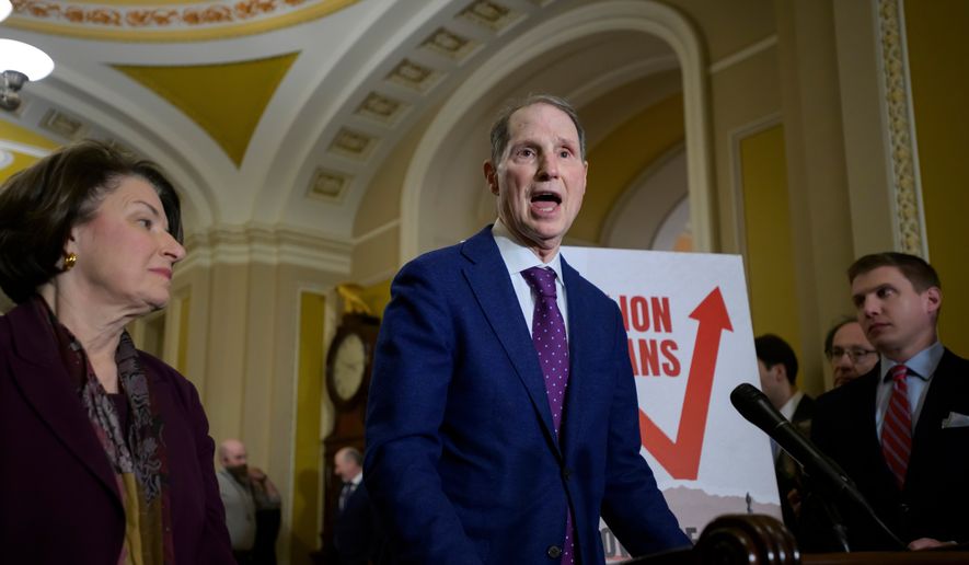 Sen. Ron Wyden, D-Ore., right, speaks as Sen. Amy Klobuchar, D-Minn., left, looks on during the Senate Democrat policy luncheon news conference at the Capitol, Dec. 2, 2025, in Washington. (AP Photo/Rod Lamkey, Jr., File)