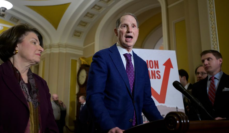 FILE - Sen. Ron Wyden, D-Ore., right, speaks as Sen. Amy Klobuchar, D-Minn., left, looks on during the Senate Democrat policy luncheon news conference at the Capitol, Dec. 2, 2025, in Washington. (AP Photo/Rod Lamkey, Jr., File)