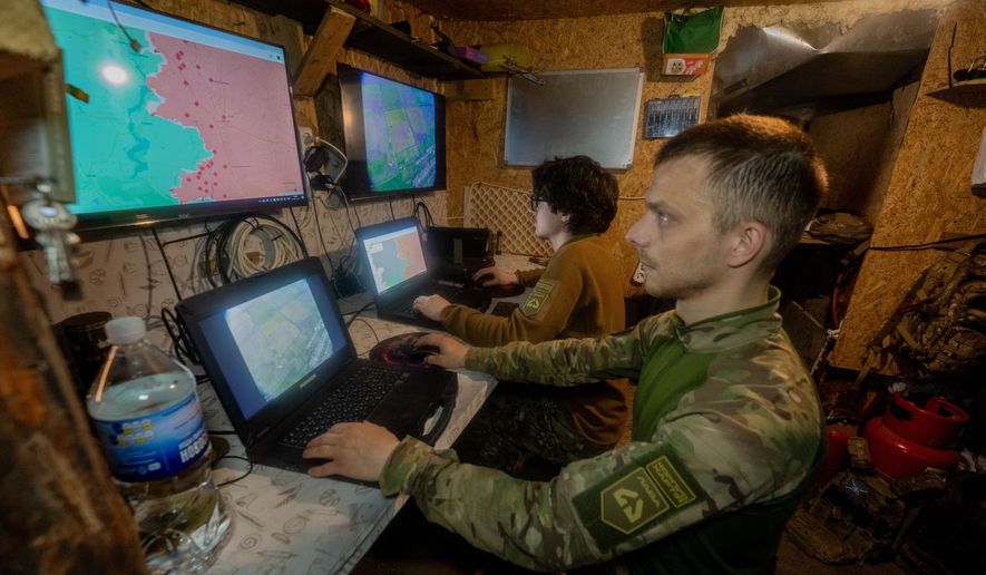 Ukrainian servicemen of Khartia brigade check the drone aerial view in the command centre Kharkiv region, Ukraine, Wednesday, May 20, 2026. (AP Photo/Andrii Marienko)