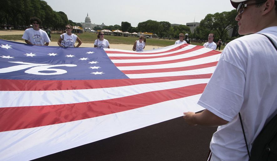 A group of volunteers from the National Youth Leaders Conference hold a giant flag during America's 2005 Independence Day Parade in Washington Monday, July 4, 2005, to celebrate the 229th birthday of the United States. (AP Photo/Lauren Victoria Burke)