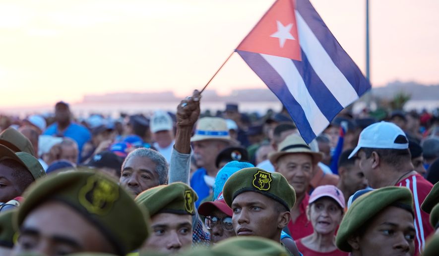 Members of the Revolutionary Armed Forces attend a rally in support of former President Raul Castro in front of the U.S. Embassy in Havana, Cuba, Friday, May 22, 2026, after U.S. prosecutors filed an indictment accusing him of ordering the 1996 shootdown of civilian planes flown by Miami-based exiles. (AP Photo/Ramon Espinosa)