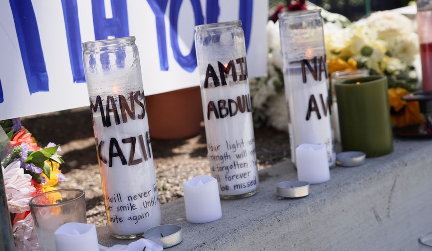 Candles with victims names are placed outside the Islamic Center of San Diego in the aftermath of a shooting on Wednesday, May 20, 2026, in San Diego. (AP Photo/Ty Oneil)