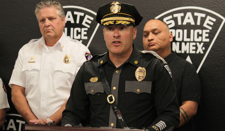 New Mexico State Police Chief Matt Broom, center, provides updates during a news conference in Albuquerque, New Mexico, on Friday, May 22, 2026 about an investigation into the deaths of three people in Torrance County and a potential fentanyl exposure for first responders who answered the call. The investigation is ongoing. (AP Photo/Susan Montoya Bryan)