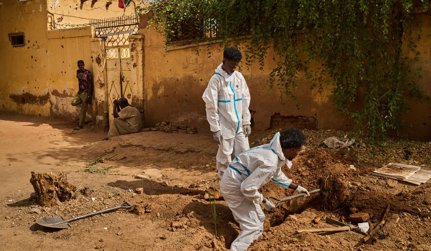 Staff from Sudan's Forensic Medicine Corporation exhume the body of Mohammed Alsawi, 73, who was killed in 2023 by the paramilitary Rapid Support Forces, or RSF, in Omdurman, Sudan, Monday, April 20, 2026. (AP Photo/Bernat Armangue)
