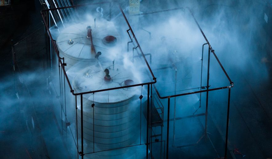 Water is sprayed on a tank that overheated at an aerospace plant in Garden Grove, Calif., Friday, May 22, 2026. (AP Photo/Ethan Swope)