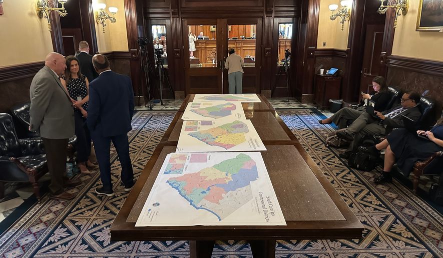 Maps for new congressional districts in South Carolina are shown in the South Carolina Senate antechamber on Friday, May 22, 2026, in Columbia, S.C. (AP Photo/Jeffrey Collins)