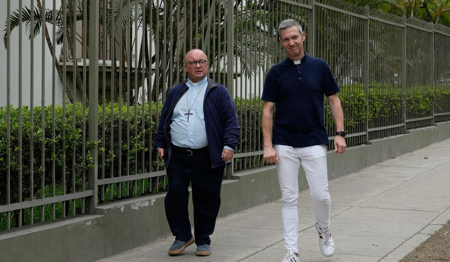 Vatican investigators Monsignor Jordi Bertomeu, right, from Spain, and Archbishop Charles Scicluna, from Malta, walk outside of the Nunciatura Apostolica during a break from meeting with people who alleged abuse by the Catholic lay group Sodalitium Christianae Vitae in Lima, Peru, on July 25, 2023. (AP Photo/Martin Mejia, File)